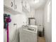 Functional laundry room with washer, dryer, utility sink, and storage cabinets for an organized space at 4005 W Coachman Ave, Tampa, FL 33611