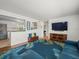 Bright living room featuring hardwood floors, a blue sofa, a palm-leaf rug, and an open floor plan at 4005 W Coachman Ave, Tampa, FL 33611