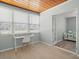 Bright office area with desk, large windows, tile floor and seating area, perfect for work or relaxation at 4005 W Coachman Ave, Tampa, FL 33611