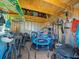 Interior of storage shed filled with storage racks, surfboards, bikes, and lawn equipment at 4005 W Coachman Ave, Tampa, FL 33611