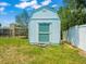 Storage shed with grass lawn and white fence, ready to store your lawn and garden equipment at 4005 W Coachman Ave, Tampa, FL 33611