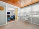Bright sunroom with wood ceiling, tile floors, and home office, adjacent to cozy living room at 4005 W Coachman Ave, Tampa, FL 33611