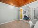 Bright sunroom with wood ceiling and tile floors, showing view into living room at 4005 W Coachman Ave, Tampa, FL 33611