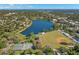 Aerial community view of green spaces, lake, baseball field, and tennis courts on a sunny day at 427 21St N Ave, St Petersburg, FL 33704