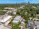 An aerial view of a home's exterior with a city skyline in the distance on a sunny day at 427 21St N Ave, St Petersburg, FL 33704