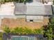 Overhead aerial view of a backyard with a screened pool and fence, surrounded by tropical plants at 427 21St N Ave, St Petersburg, FL 33704
