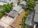 Aerial view of a backyard featuring a screened pool, fenced yard and lush, tropical landscaping at 427 21St N Ave, St Petersburg, FL 33704