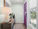 Inviting entryway featuring a stylish console table with decor, a bright window, and a unique purple door at 427 21St N Ave, St Petersburg, FL 33704