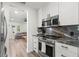 Modern kitchen featuring stainless steel appliances and marble countertops with an open-concept design at 427 21St N Ave, St Petersburg, FL 33704
