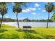Scenic view of a bench overlooking a serene lake with palm trees and blue skies in the background at 427 21St N Ave, St Petersburg, FL 33704