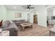 Spacious living room featuring a comfortable gray sectional couch and modern wood-look flooring at 427 21St N Ave, St Petersburg, FL 33704
