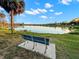 Park bench view offers a relaxing escape with a scenic lake and blue skies in the background at 427 21St N Ave, St Petersburg, FL 33704
