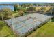 Aerial view of outdoor pickleball courts with players, surrounded by trees, grass, and a lake at 427 21St N Ave, St Petersburg, FL 33704