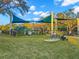 Community playground with swings, climbing structures, and benches on a sunny day at 427 21St N Ave, St Petersburg, FL 33704