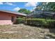 View of the backyard with a pool and screened enclosure from a distance at 4388 Tiffin Ave, Spring Hill, FL 34609