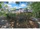 Backyard of this house with a pool enclosure and a small row of bushes at 4388 Tiffin Ave, Spring Hill, FL 34609