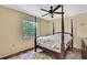 Bedroom featuring a four poster bed, hardwood floors, and natural light at 4388 Tiffin Ave, Spring Hill, FL 34609