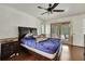 Bedroom with hardwood floors, a large bed, and access to an outdoor patio at 4388 Tiffin Ave, Spring Hill, FL 34609