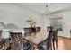 A formal dining room featuring hardwood floors and decorative lighting at 4388 Tiffin Ave, Spring Hill, FL 34609