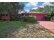 Single-story home with a garage and mature landscaping in need of maintenance at 4388 Tiffin Ave, Spring Hill, FL 34609