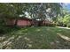 Home's front yard with a large tree and green lawn at 4388 Tiffin Ave, Spring Hill, FL 34609