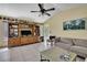 Inviting living room with vaulted ceilings, tile floors, and built-in wooden entertainment center at 4388 Tiffin Ave, Spring Hill, FL 34609