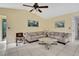 Comfortable living room with neutral walls, tile flooring, and plush sofas at 4388 Tiffin Ave, Spring Hill, FL 34609