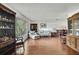 Sunlit living room with hardwood floors and a large window view at 4388 Tiffin Ave, Spring Hill, FL 34609