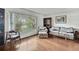 A cozy living room featuring hardwood floors and a large window view at 4388 Tiffin Ave, Spring Hill, FL 34609