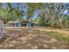 Beautiful backyard with mature trees and plenty of space for outdoor activities and entertaining at 525 Gornto Lake Rd, Brandon, FL 33510