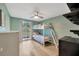 Bright bedroom featuring wood floors, painted walls, and a window with backyard views at 525 Gornto Lake Rd, Brandon, FL 33510