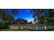 Charming blue single-story home with a well-manicured lawn, mature trees, and an inviting facade at 525 Gornto Lake Rd, Brandon, FL 33510