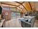 Inviting living room with wood-paneled walls, stone fireplace, and sliding glass doors to the backyard at 525 Gornto Lake Rd, Brandon, FL 33510
