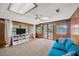 Spacious living room featuring wood paneling, ceiling fan, and a large sliding door at 525 Gornto Lake Rd, Brandon, FL 33510