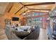 Cozy living room featuring wood paneling, stone fireplace and a large sliding door with lake view at 525 Gornto Lake Rd, Brandon, FL 33510