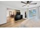 Bedroom with wood floors, view to living room, and sliding doors to the backyard at 525 Gornto Lake Rd, Brandon, FL 33510