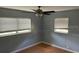 View of the bedroom with hardwood floors, ceiling fan, and windows at 5991 42Nd N Ave, St Petersburg, FL 33709
