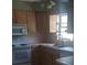 A practical kitchen with wooden cabinets, standard appliances, and a double sink at 5991 42Nd N Ave, St Petersburg, FL 33709