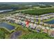 An aerial view displays a home in a well-planned community with lush landscaping, ponds, and mature trees at 6154 Marsh Trail Dr, Odessa, FL 33556