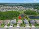 This aerial view showcases a well-kept property in a planned community with lush greenery and convenient access to neighborhood amenities at 6154 Marsh Trail Dr, Odessa, FL 33556