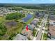 An aerial view of a well-maintained, single-Gathering home in a lush, planned community with mature trees and a neighborhood pool at 6154 Marsh Trail Dr, Odessa, FL 33556