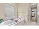 Tranquil bathroom features a soaking tub with tray and a window with a view, plus a separate shower at 6154 Marsh Trail Dr, Odessa, FL 33556