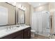 Bright bathroom features a shower/tub combo, granite counters, double vanity with stainless fixtures and hardwood floors at 6154 Marsh Trail Dr, Odessa, FL 33556