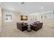 Spacious bonus room with plush carpet, recessed lighting, and comfortable leather seating around a center table at 6154 Marsh Trail Dr, Odessa, FL 33556