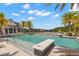A zero entry community pool features palm trees, lounge chairs, and beautiful water views in a resort-like setting at 6154 Marsh Trail Dr, Odessa, FL 33556