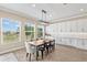 Bright dining area boasts lots of natural light, white cabinets, and space for Gathering gatherings at 6154 Marsh Trail Dr, Odessa, FL 33556
