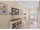 Welcoming entryway features a console table, wood floors, and archway leading to other rooms at 6154 Marsh Trail Dr, Odessa, FL 33556