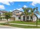 Charming white two-story home featuring a beautiful landscaped yard, tile roof, and two-car garage at 6154 Marsh Trail Dr, Odessa, FL 33556