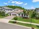 Beautiful two-story home with a well-manicured lawn, three car garage, and a tile roof at 6154 Marsh Trail Dr, Odessa, FL 33556