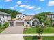 Beautiful two-story home with a well-manicured lawn, three car garage, and a tile roof at 6154 Marsh Trail Dr, Odessa, FL 33556